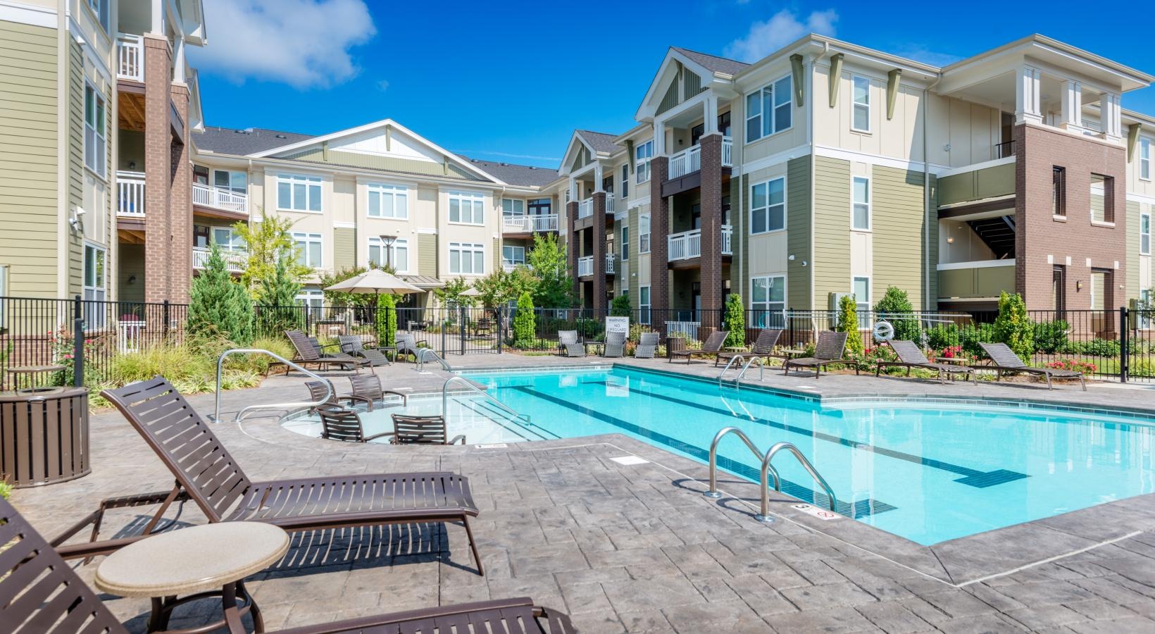 Resort-style swimming pool a pool in front of buildings