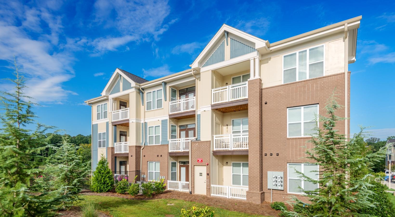 The essence of exceptional living a building with a lawn and trees