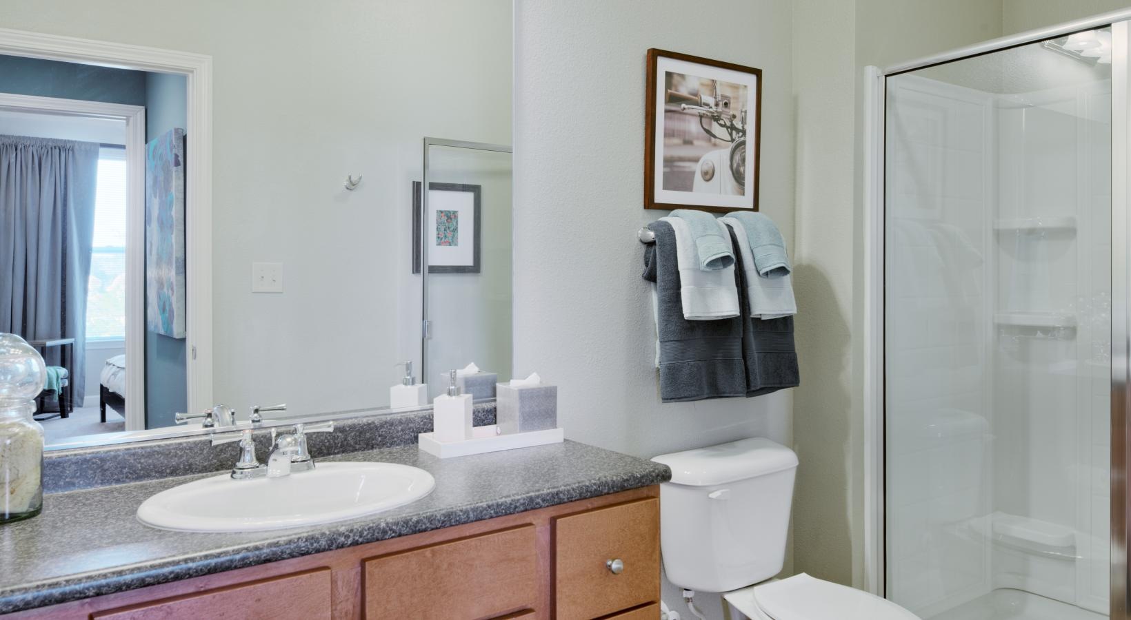 Spacious bathrooms with everything you need a bathroom with a sink toilet and mirror