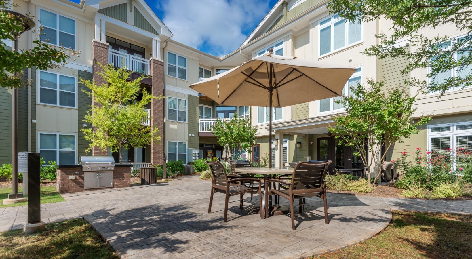 State-of-the-art amenities a patio with chairs and umbrella