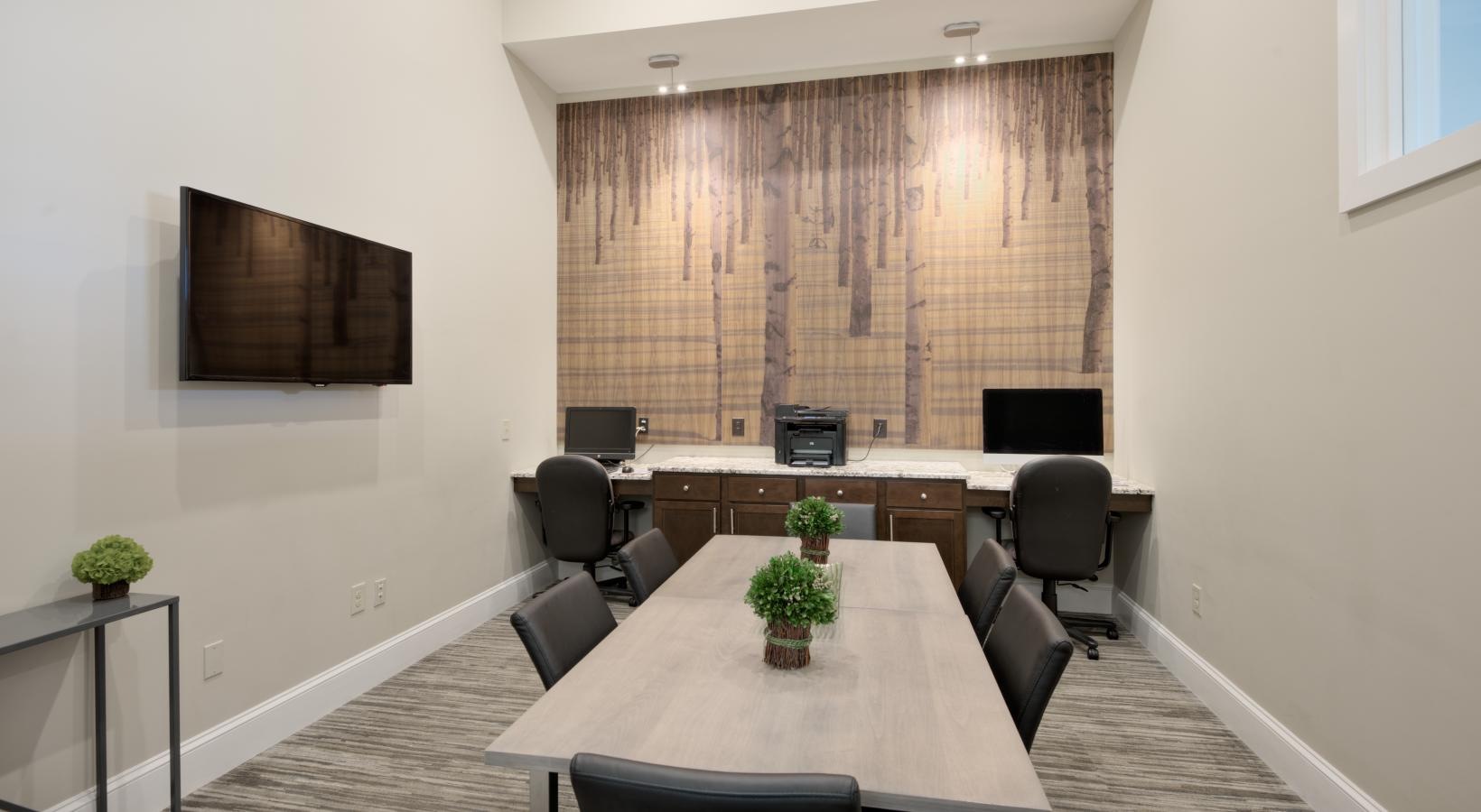 State-of-the-art amenities a clubhouse room with a table and chairs