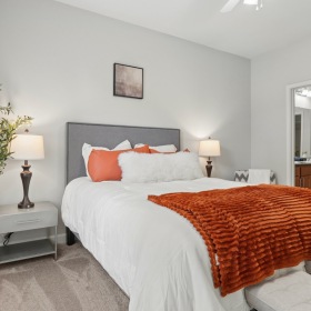 bedroom with a bed end tables and lamps
