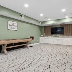 clubroom with green walls and shuffle board table